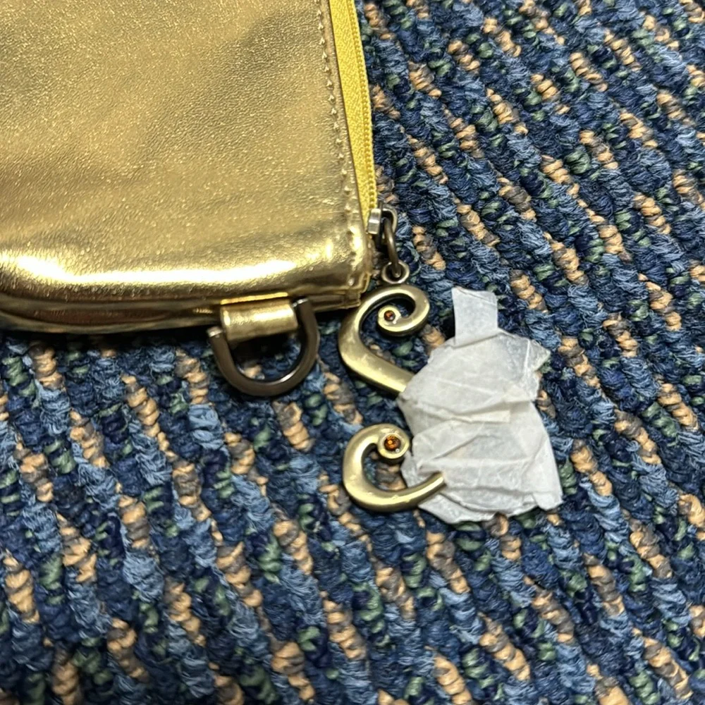 Small gold cosmetic bag w/decorative zipper pull. NWT